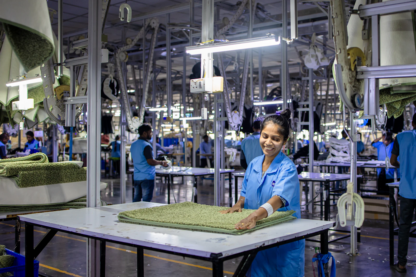 Engineer reviewing a technical blueprint on the factory floor