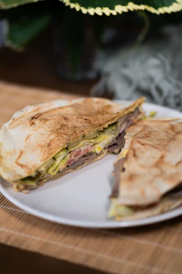 A delicious, grilled sandwich is shown on a plate.