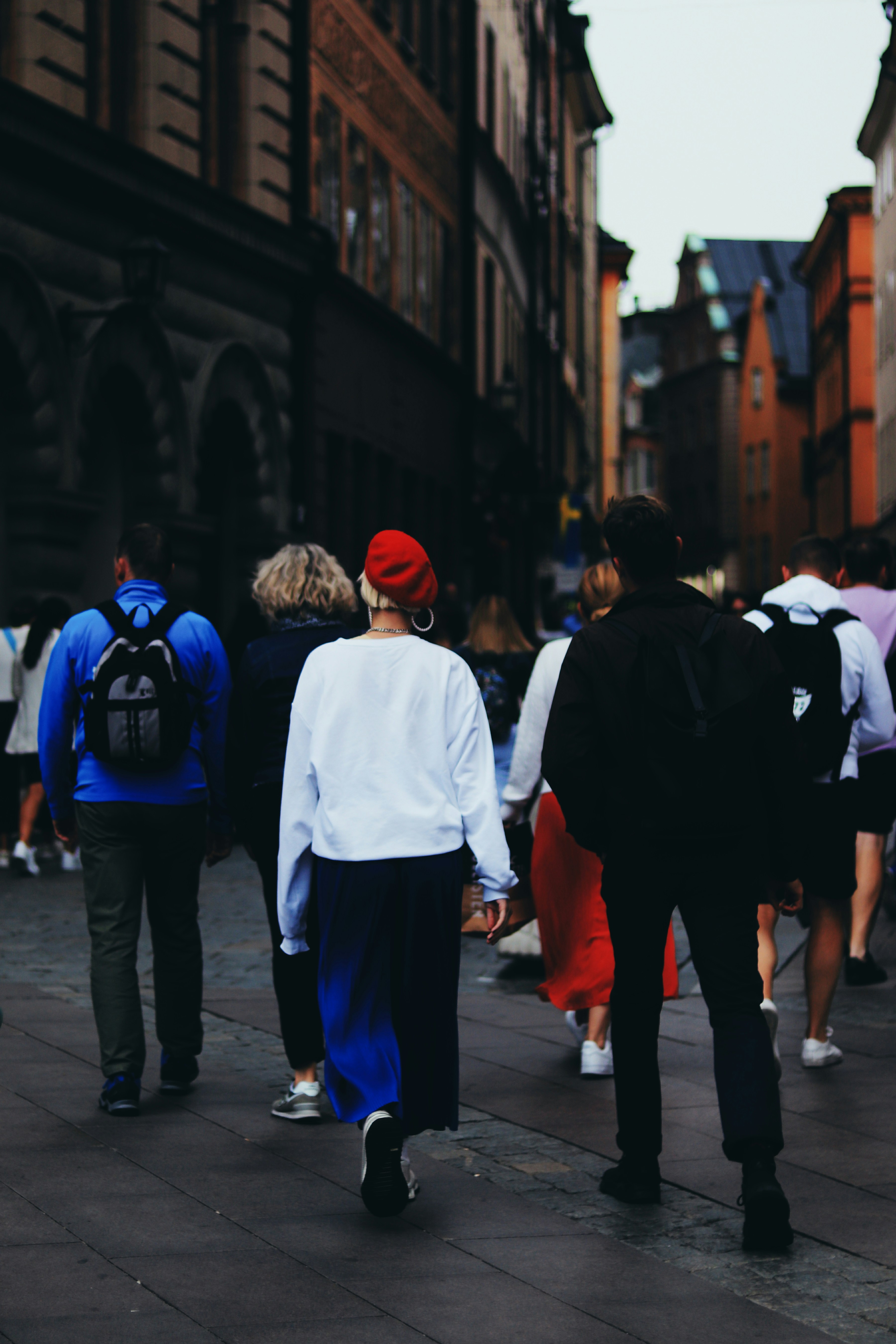 People stroll down a busy street.