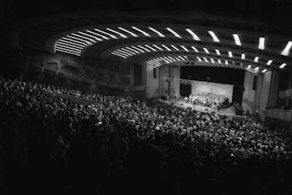 An orchestra performs for a large, attentive audience.