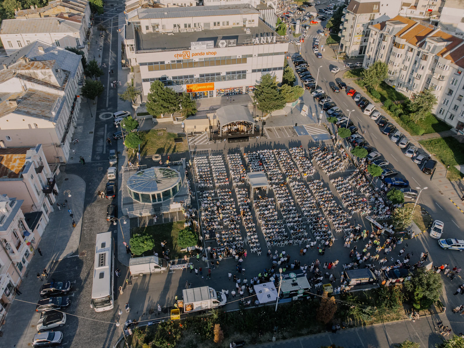 Aerial view of a large outdoor event with seated attendees