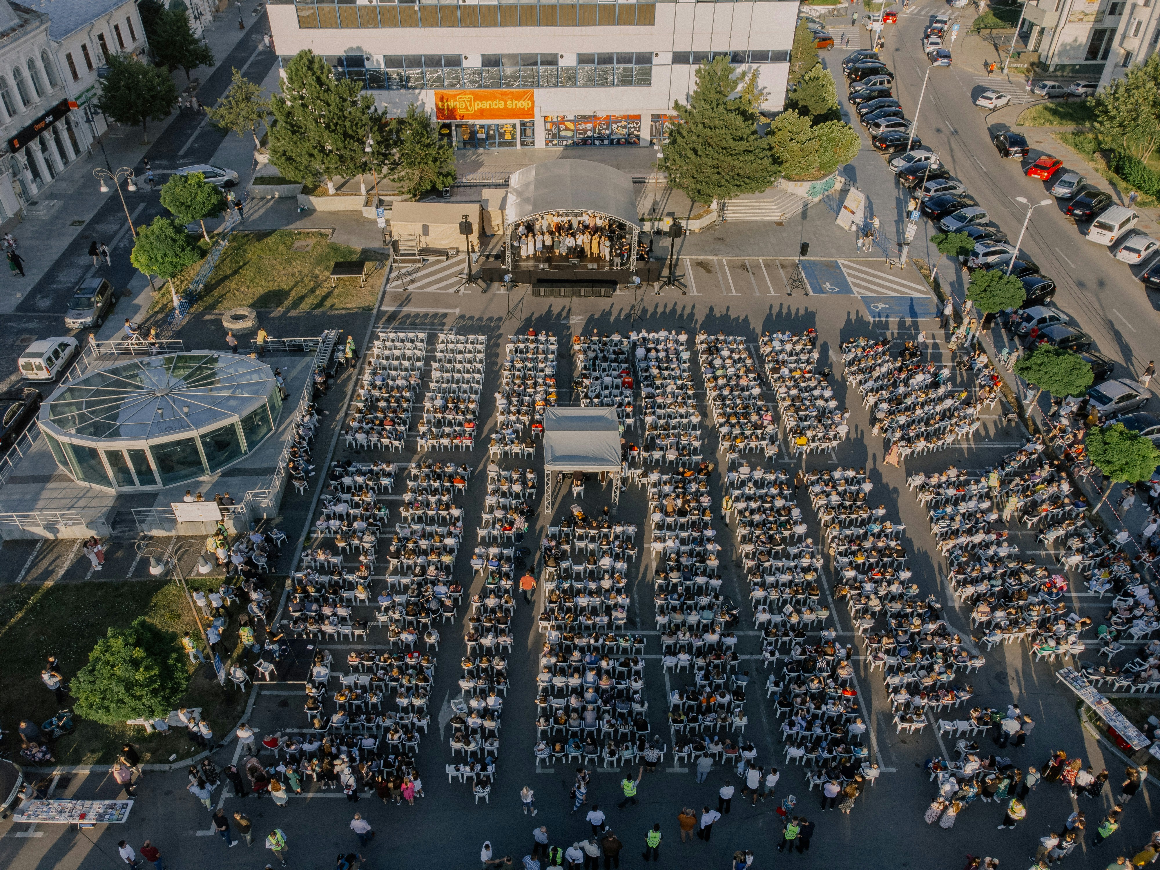 An outdoor concert is happening in front of a crowd.