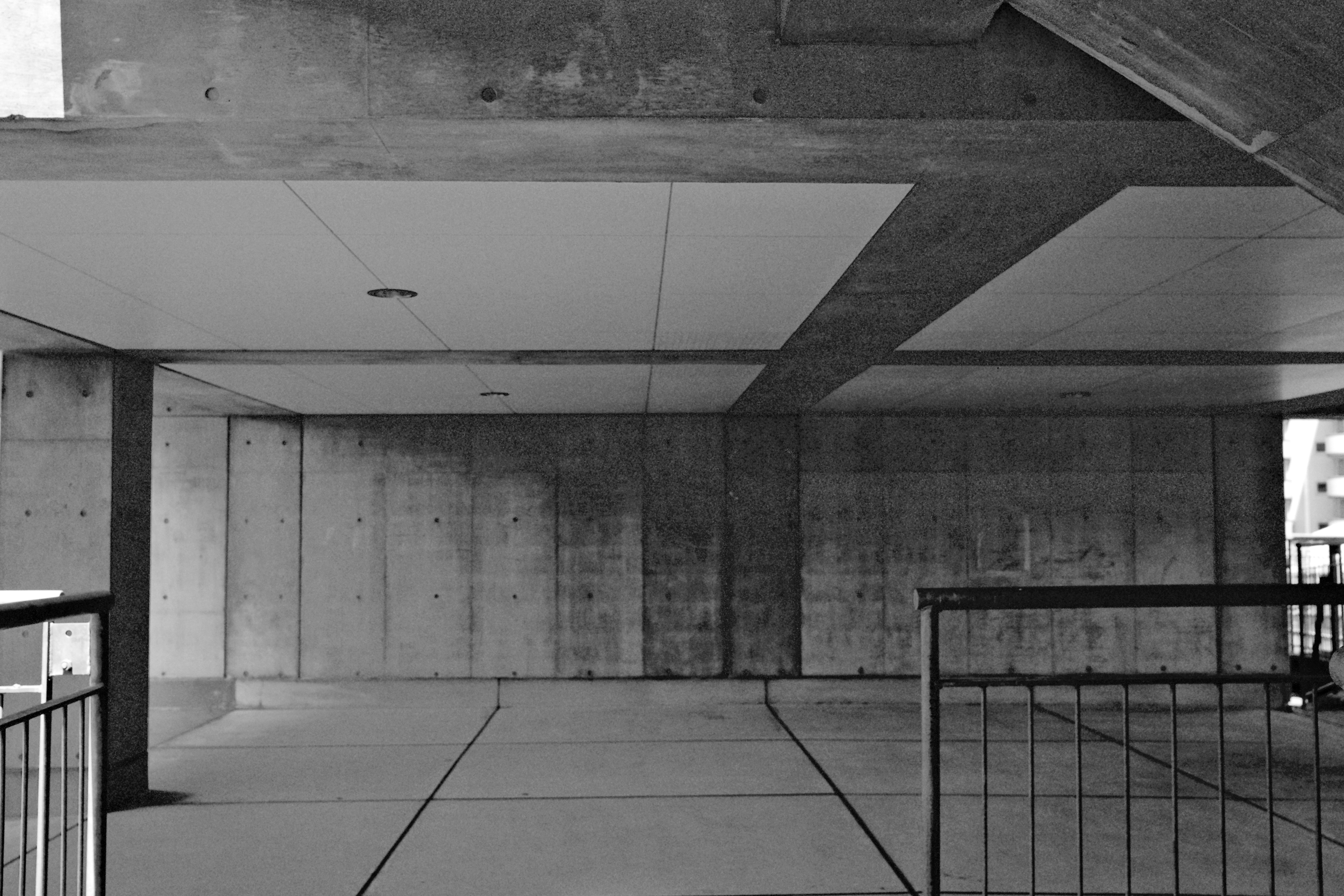 Underneath of a concrete structure, in black and white.