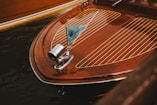 Wooden boat with flag: detail of bow.