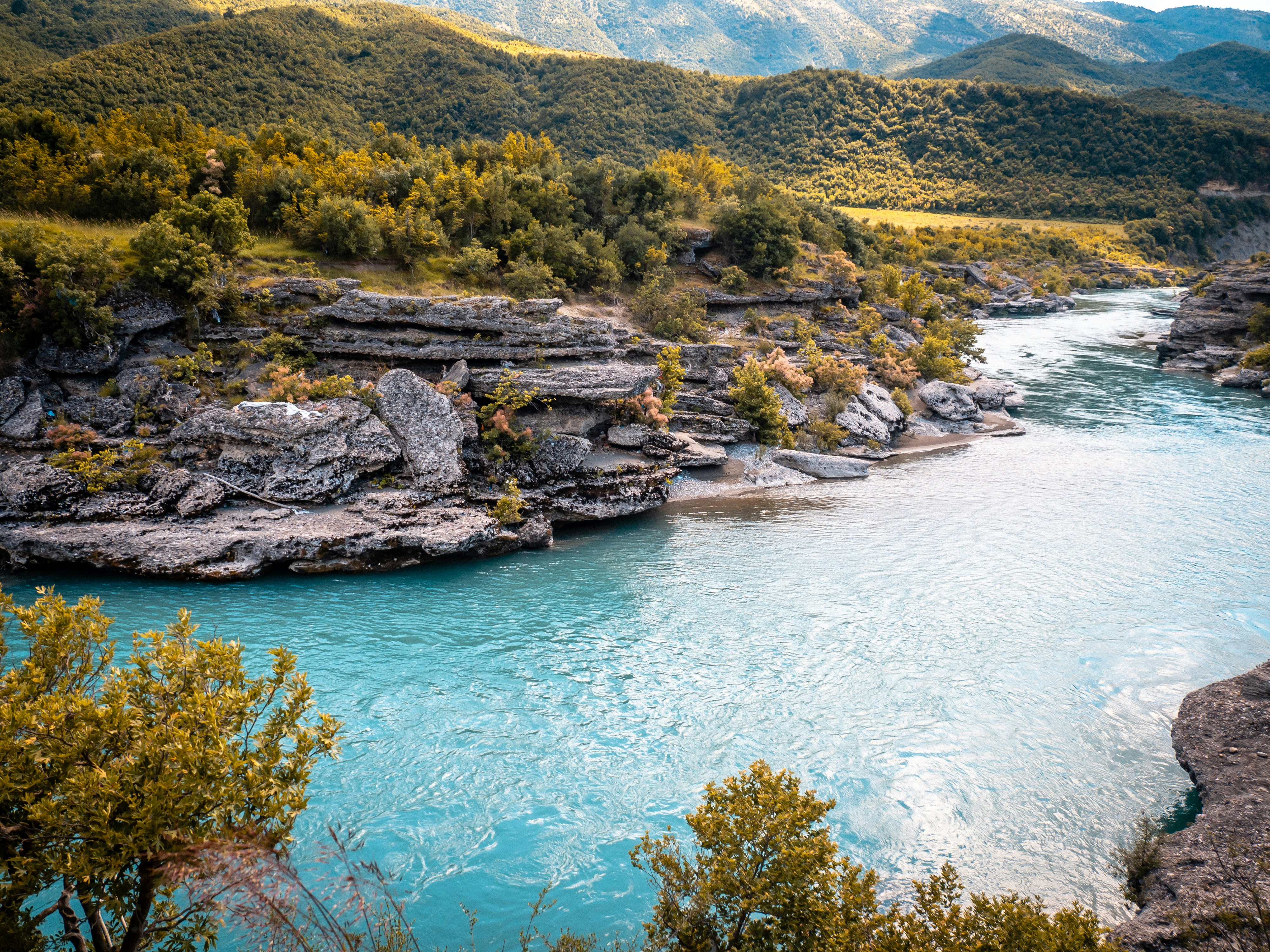 A turquoise river flows through beautiful mountains.