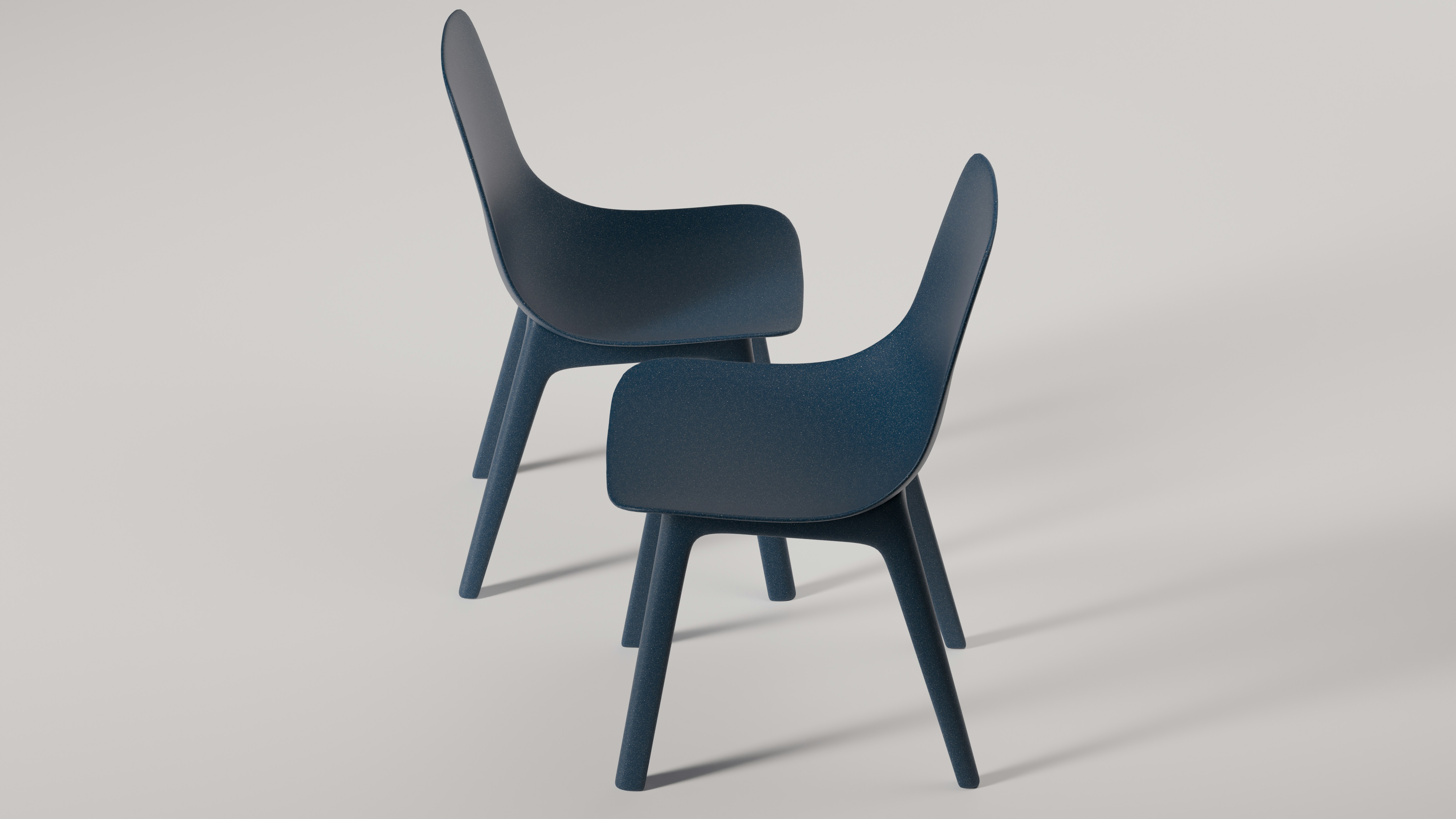 Two modern, dark-blue armchairs are on display.