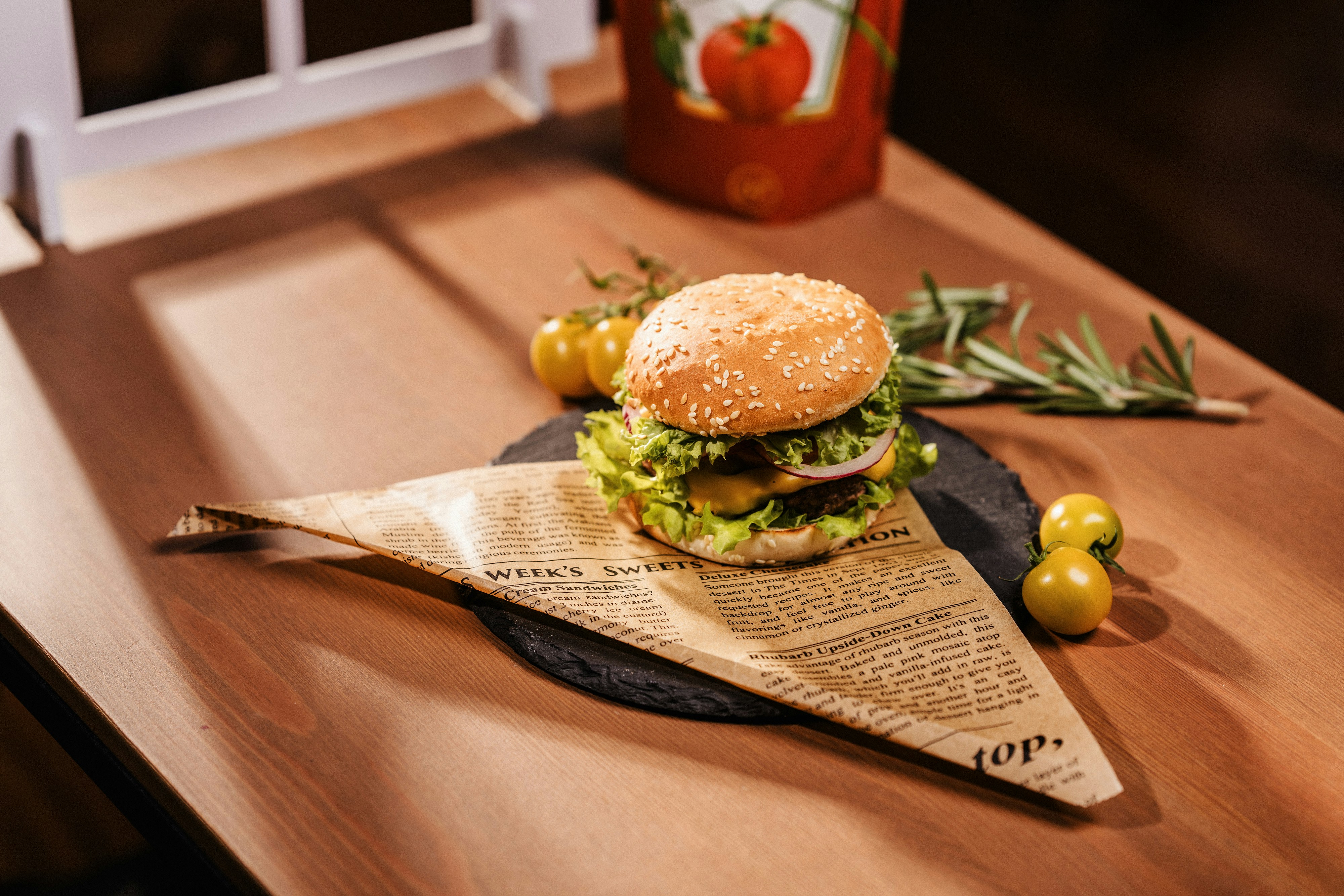 A delicious burger is placed on a wooden surface.
