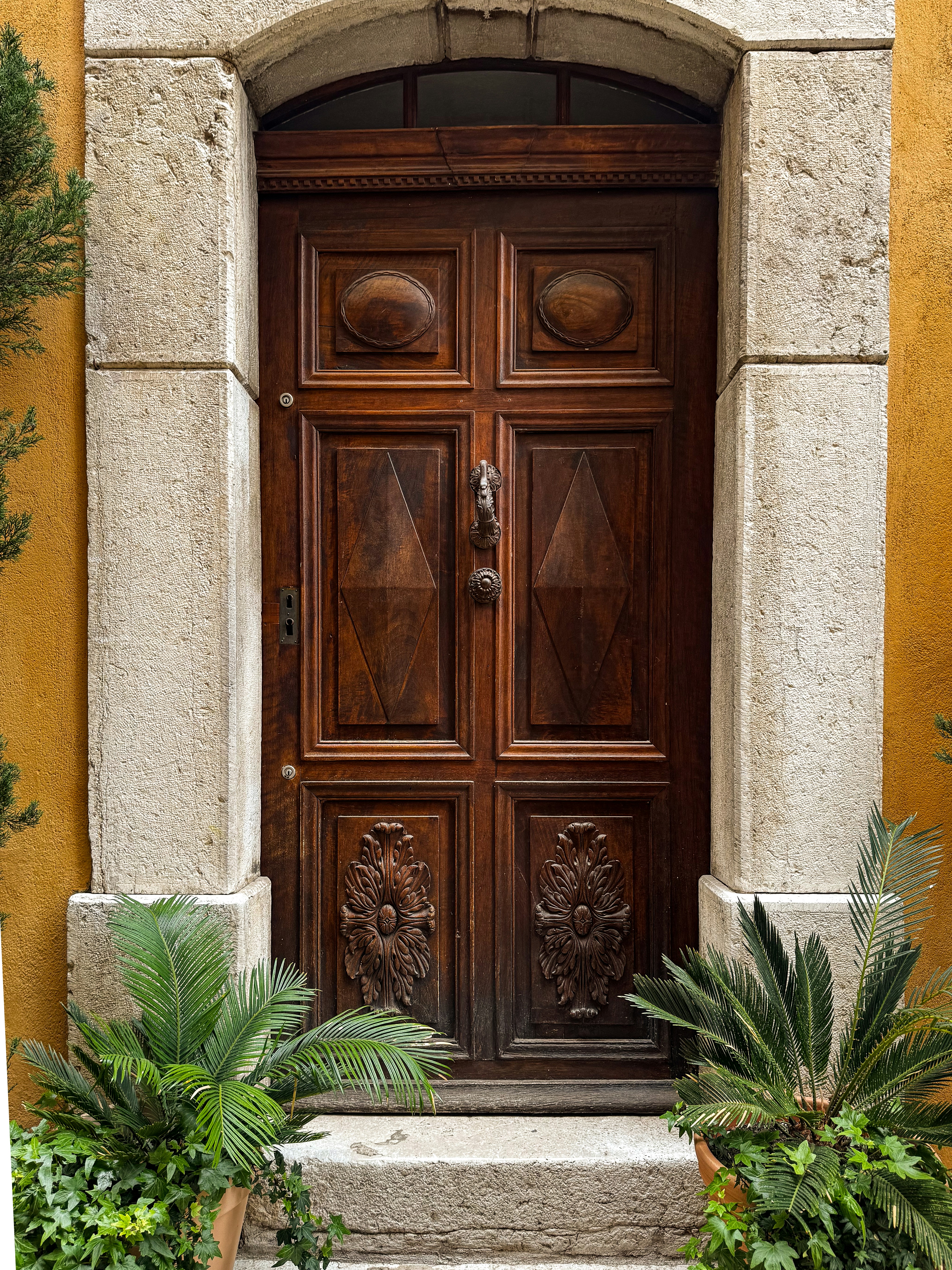 A beautiful wooden door in a stone frame.