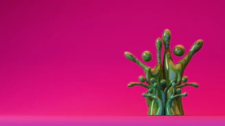 Green paint splash against a pink background.