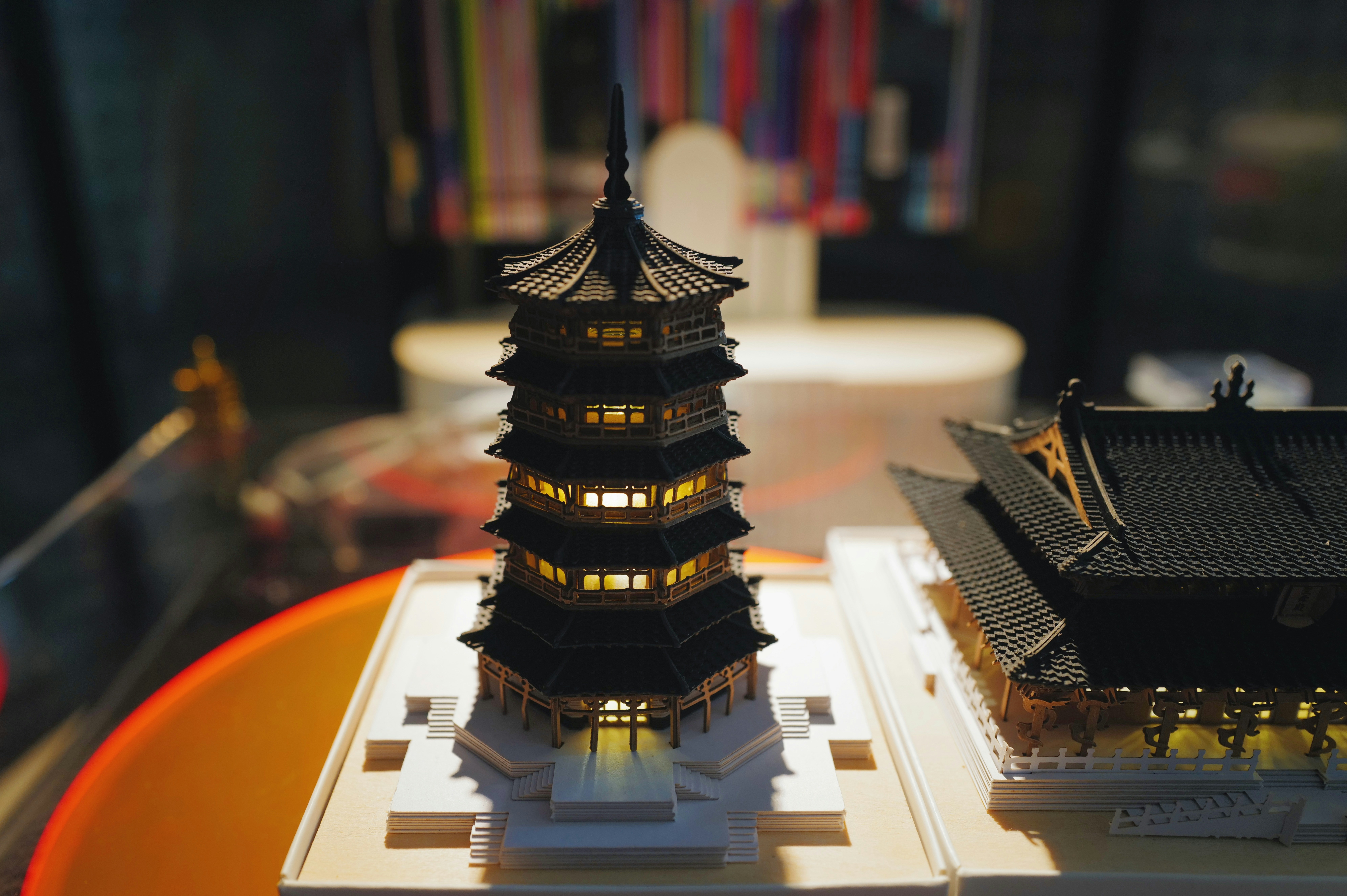 Miniature pagoda lit from within is the focus.