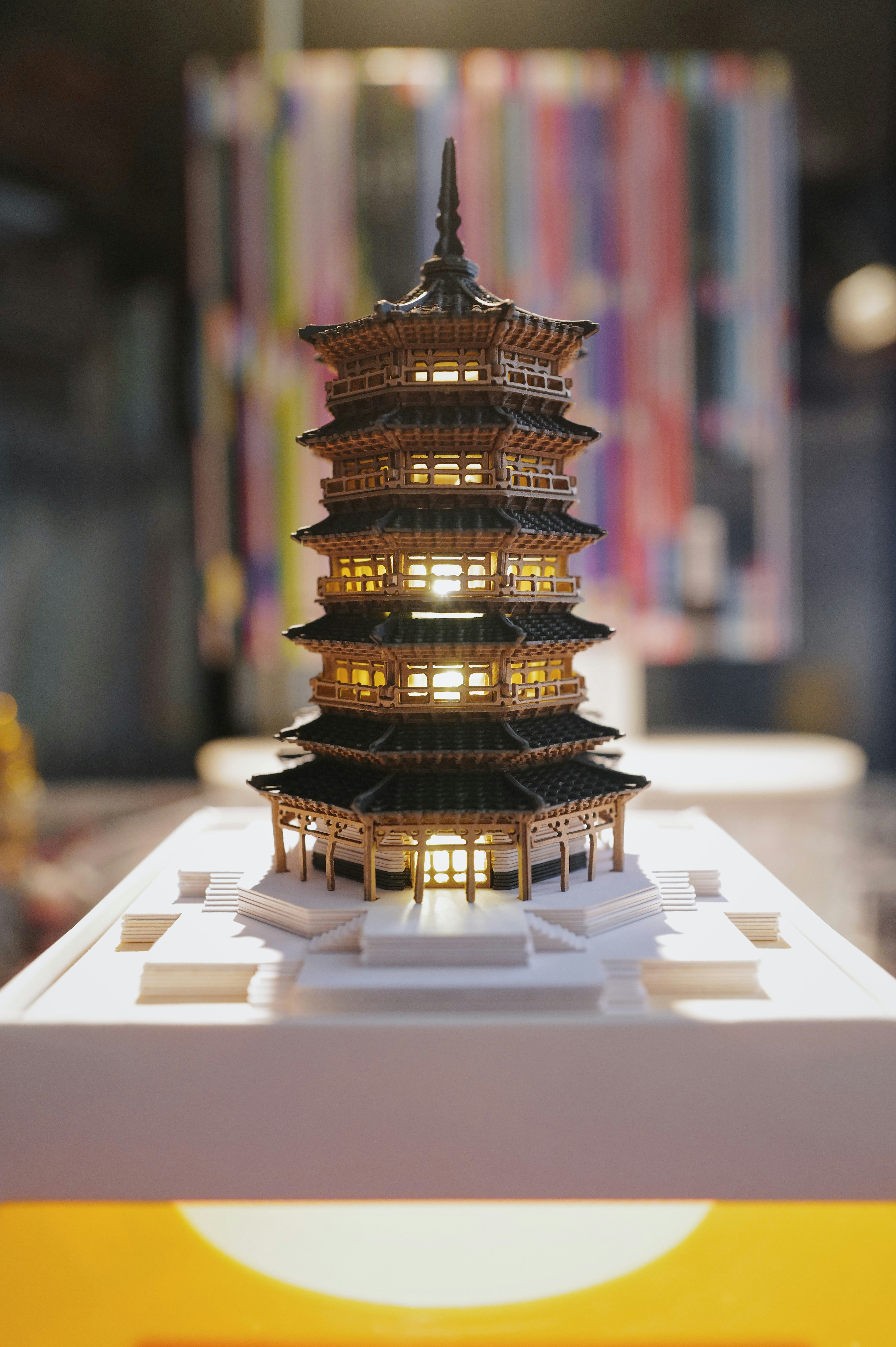A detailed miniature pagoda is beautifully illuminated.