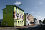 Colorful buildings stand along a quiet city street.