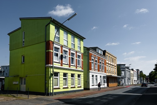 Colorful buildings stand along a quiet city street.