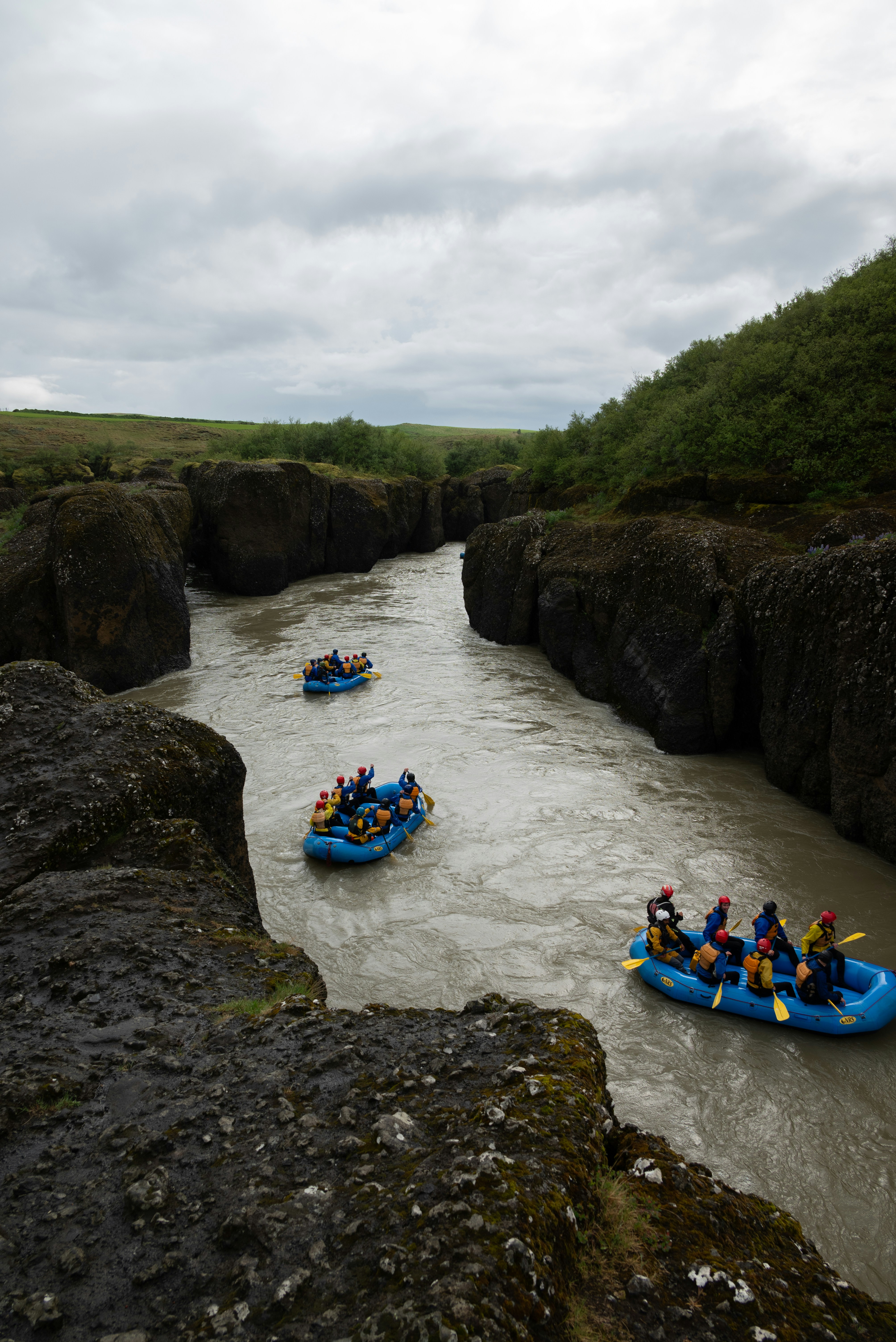 People are rafting on a river.