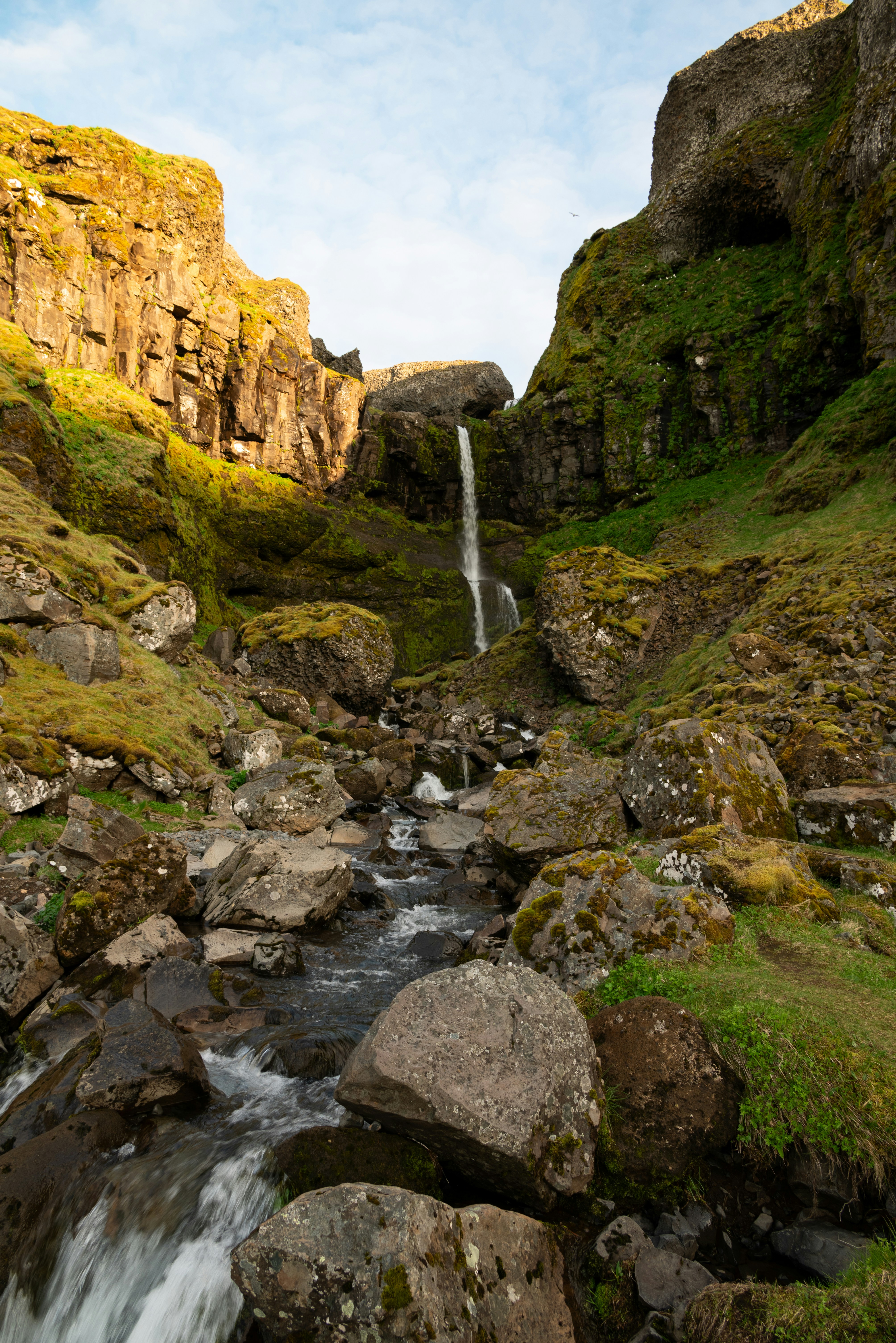 A waterfall cascades down a rocky canyon.