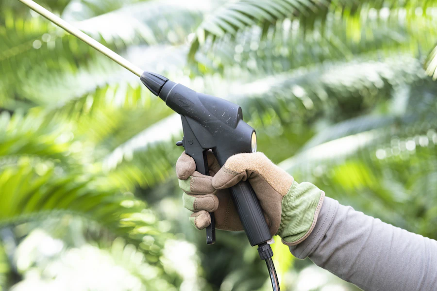 Technician performing termite soil treatment with professional spraying equipment