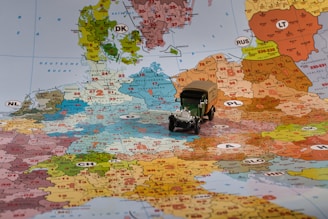 A miniature truck travels across a european map.