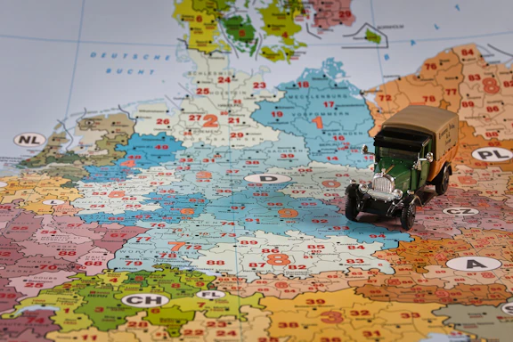 A toy truck rests on a map of germany.