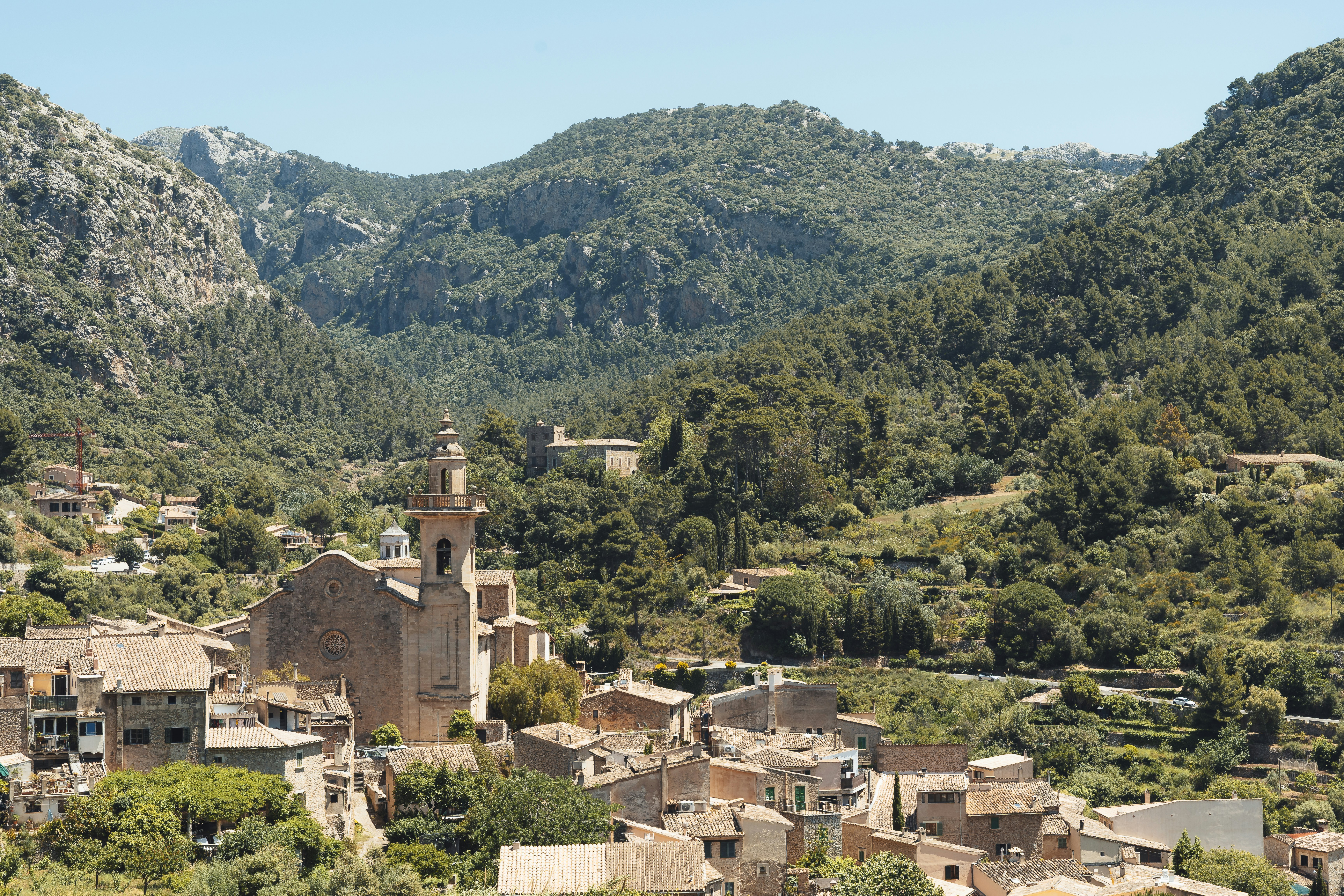 A village nestled between lush mountains.