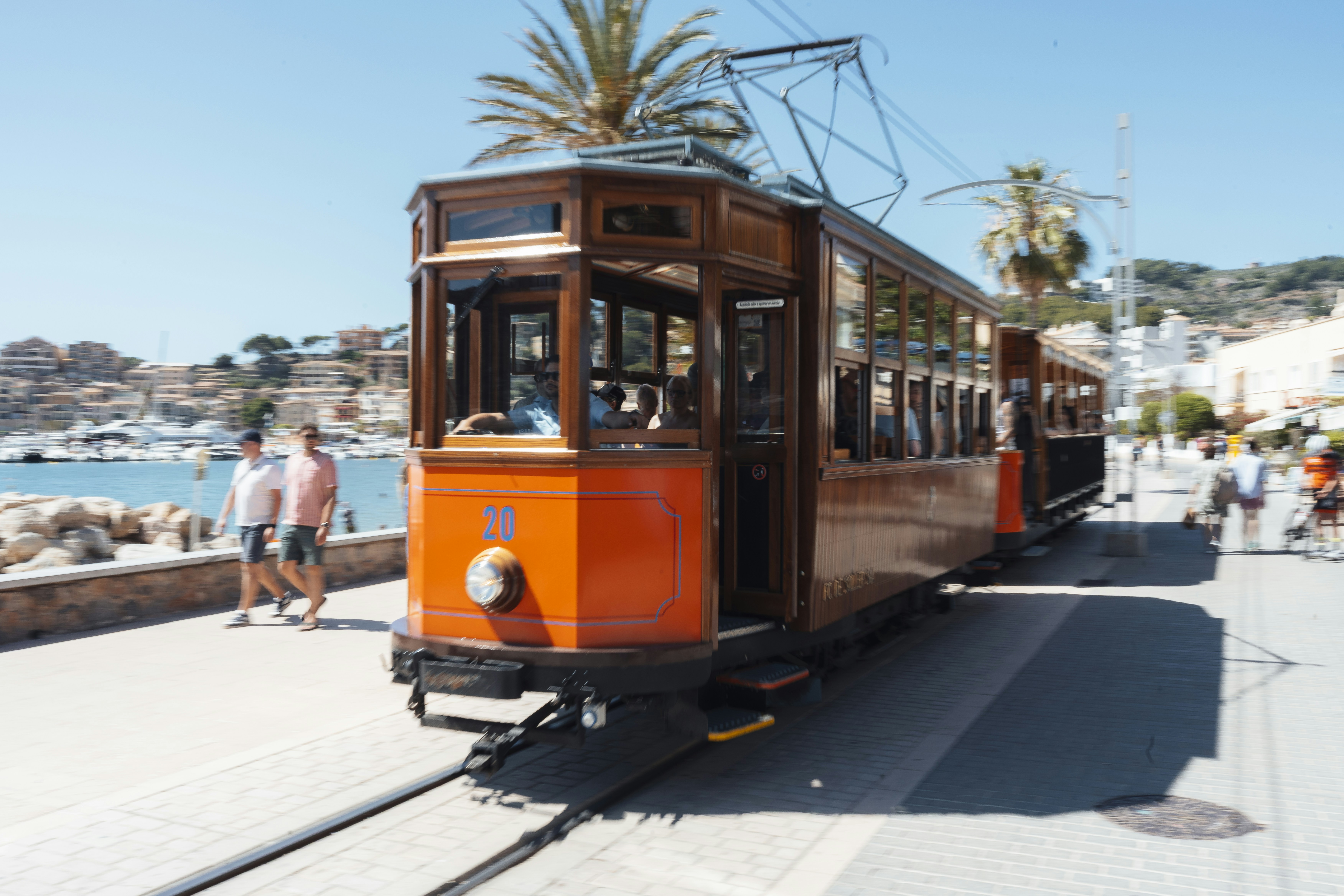 A vintage tram sits near the coast.