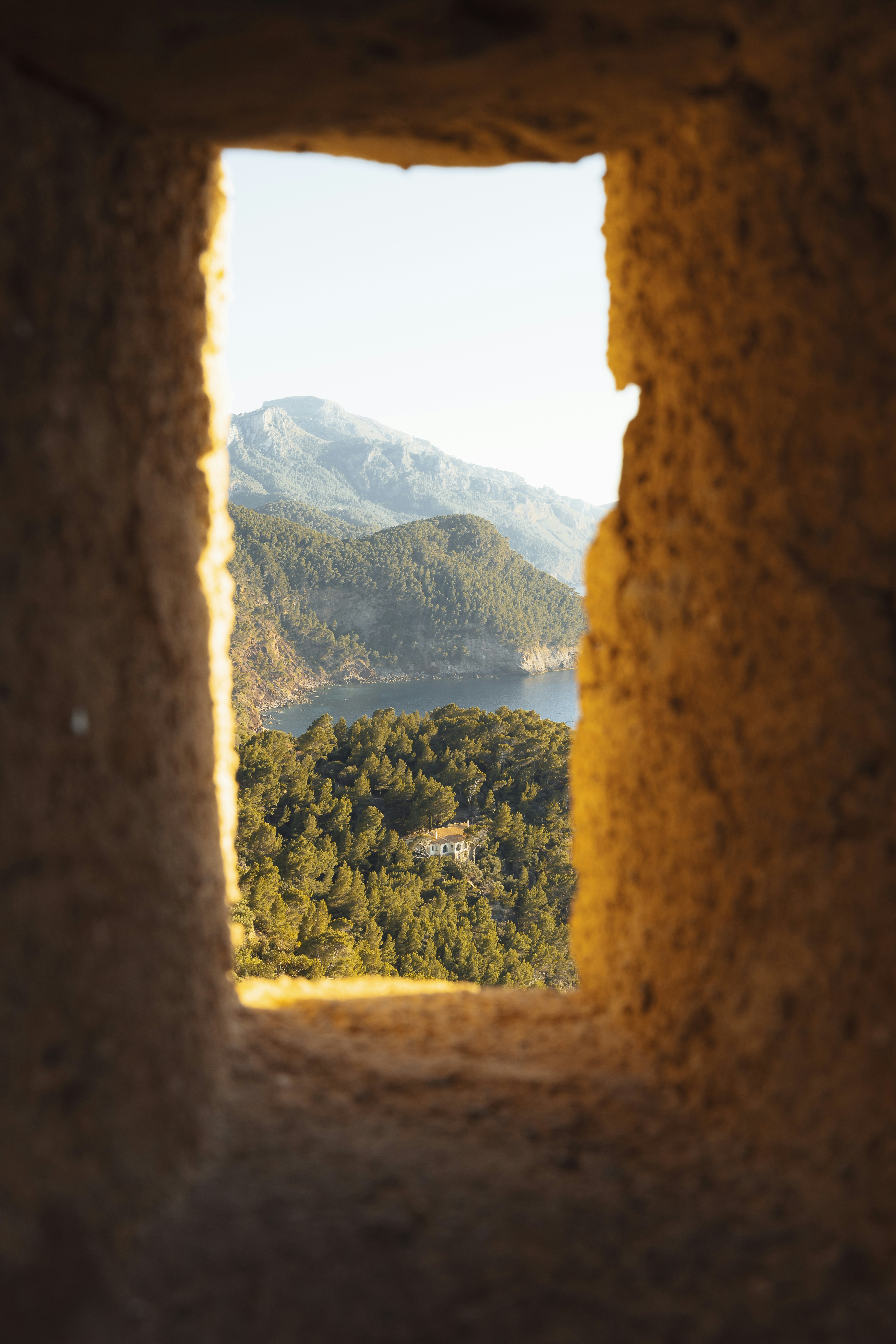 A view of mountains through a stone window.