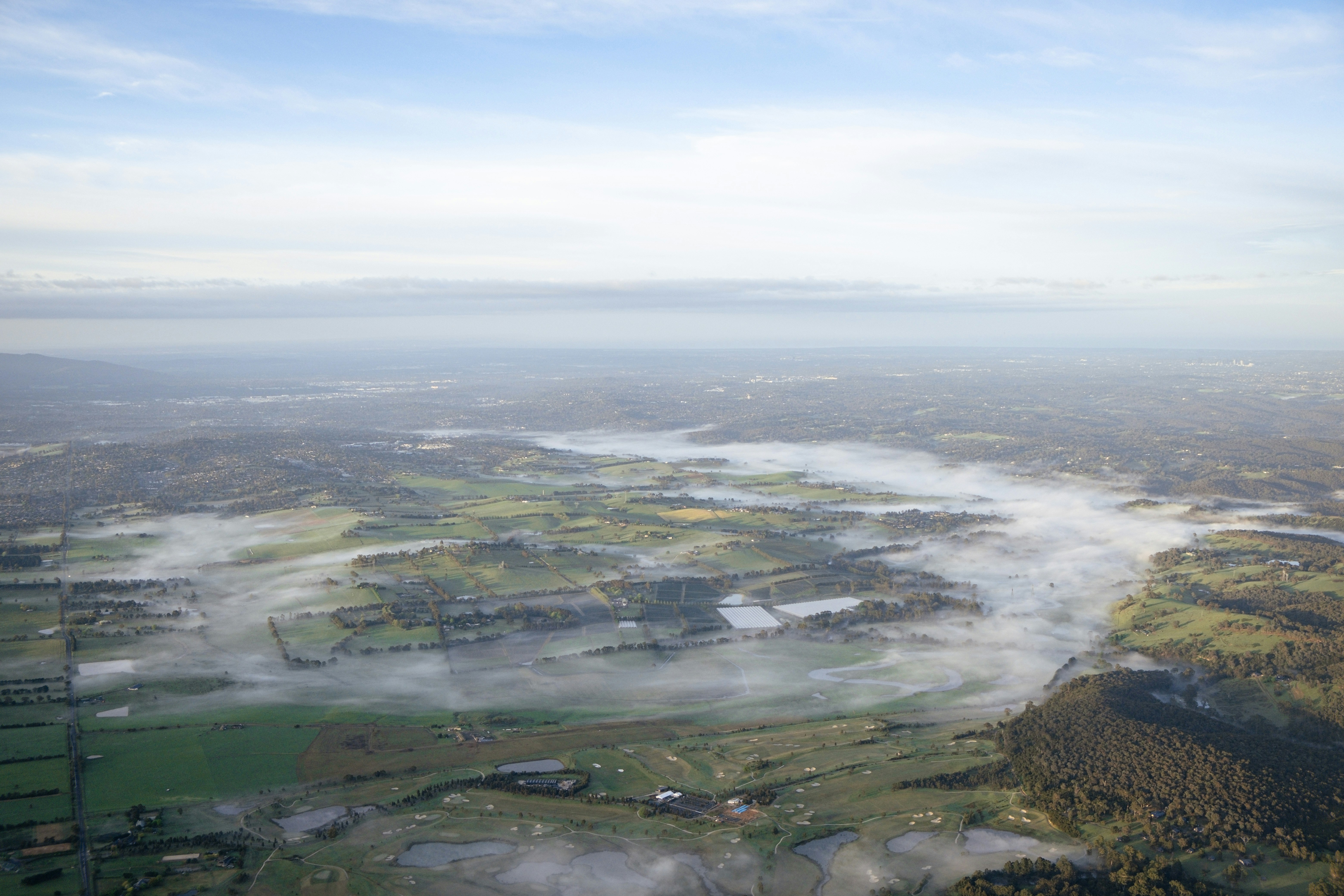 Overhead view of a landscape with morning fog.