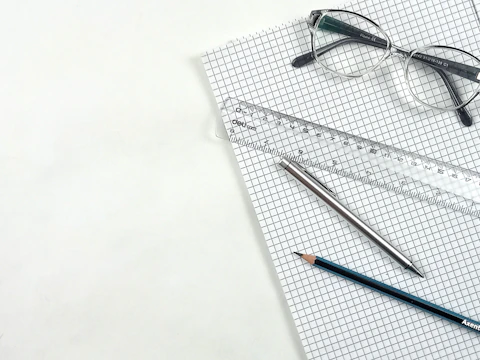 Notebook, glasses, pencil, ruler and pen.