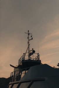 Ship's mast and radar against the evening sky.