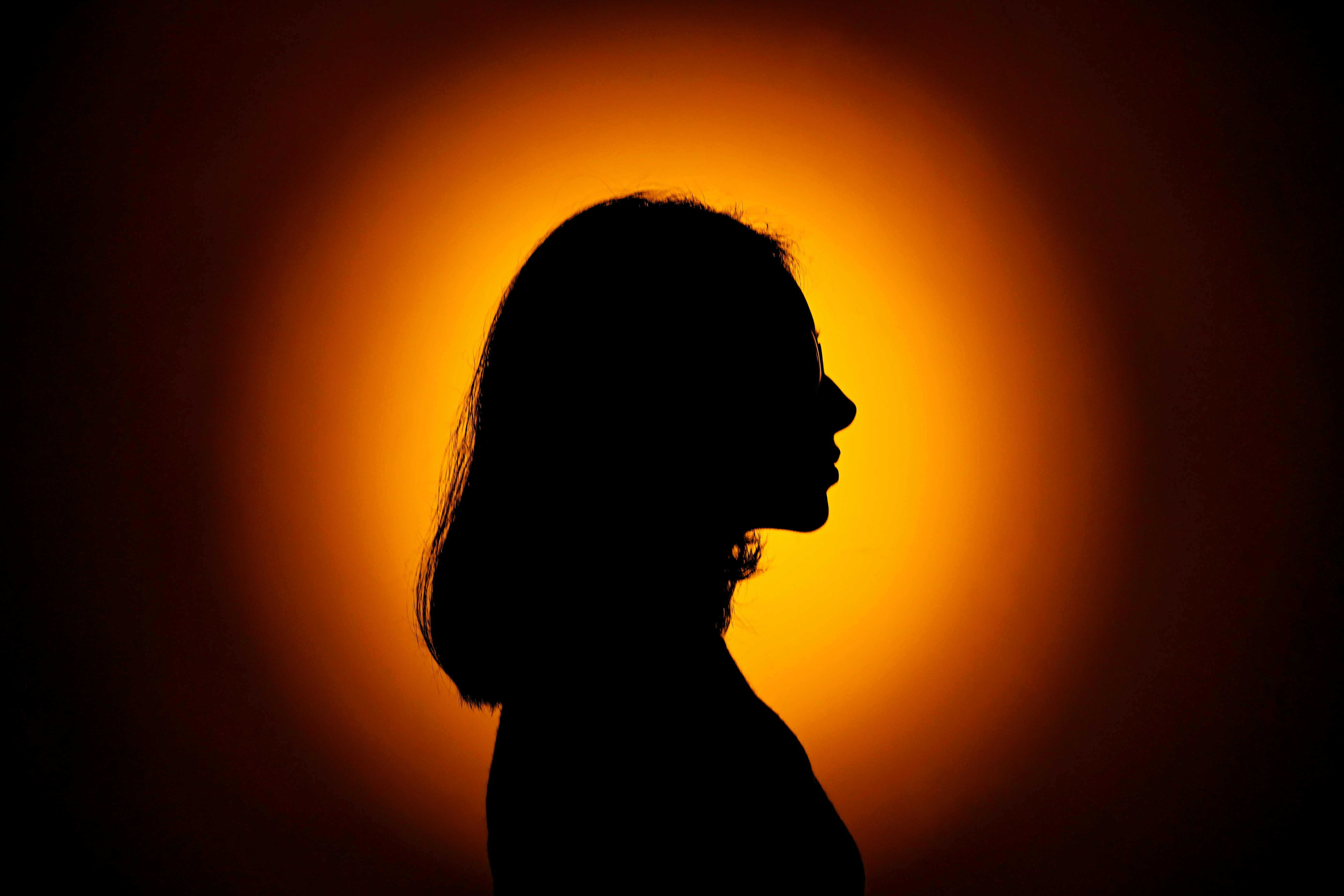 Silhouette of a woman against a bright background.