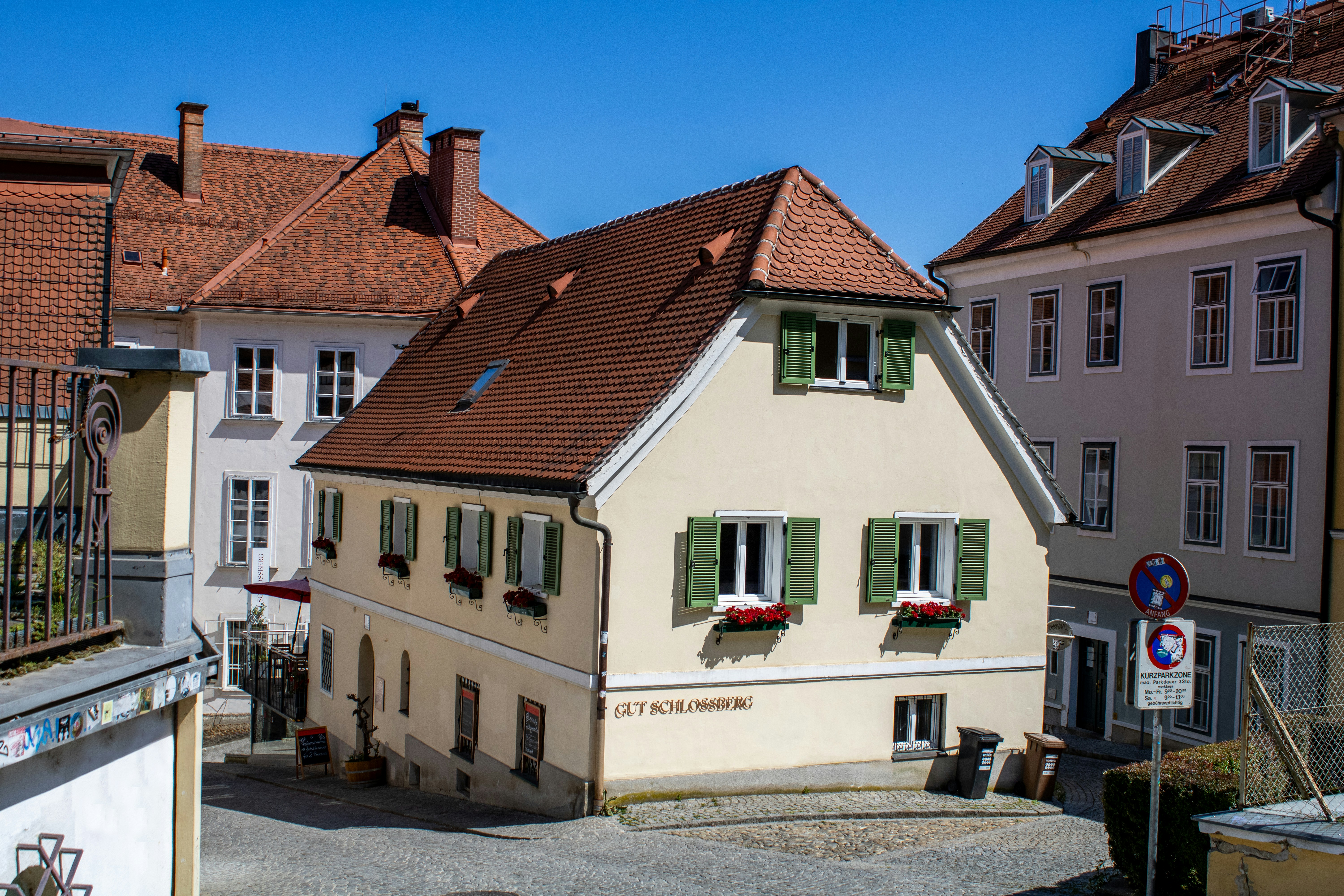 A charming house sits among other buildings.
