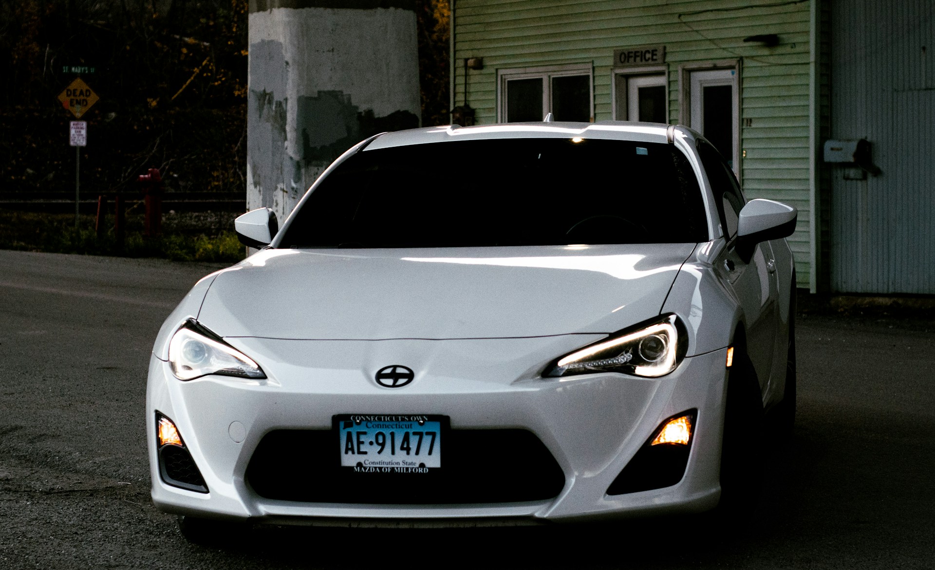A white scion fr-s sports car is parked.