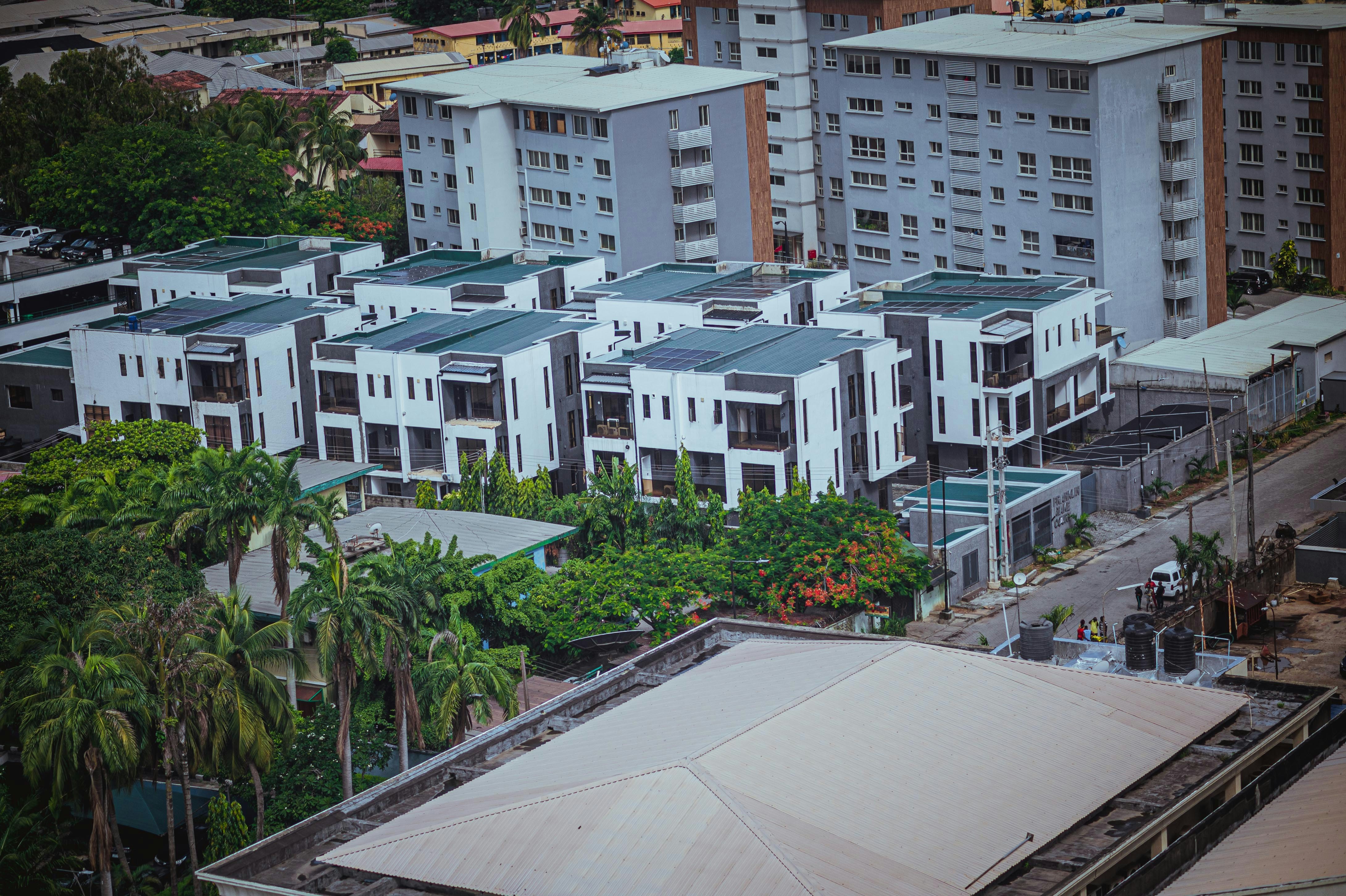 Modern townhouses stand near apartment buildings.
