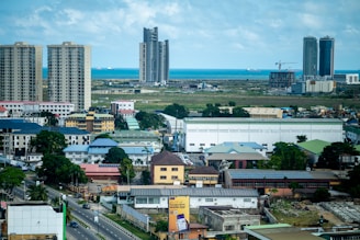 Cityscape featuring buildings, sky, and ocean.