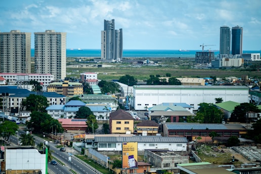 Cityscape featuring buildings, sky, and ocean.