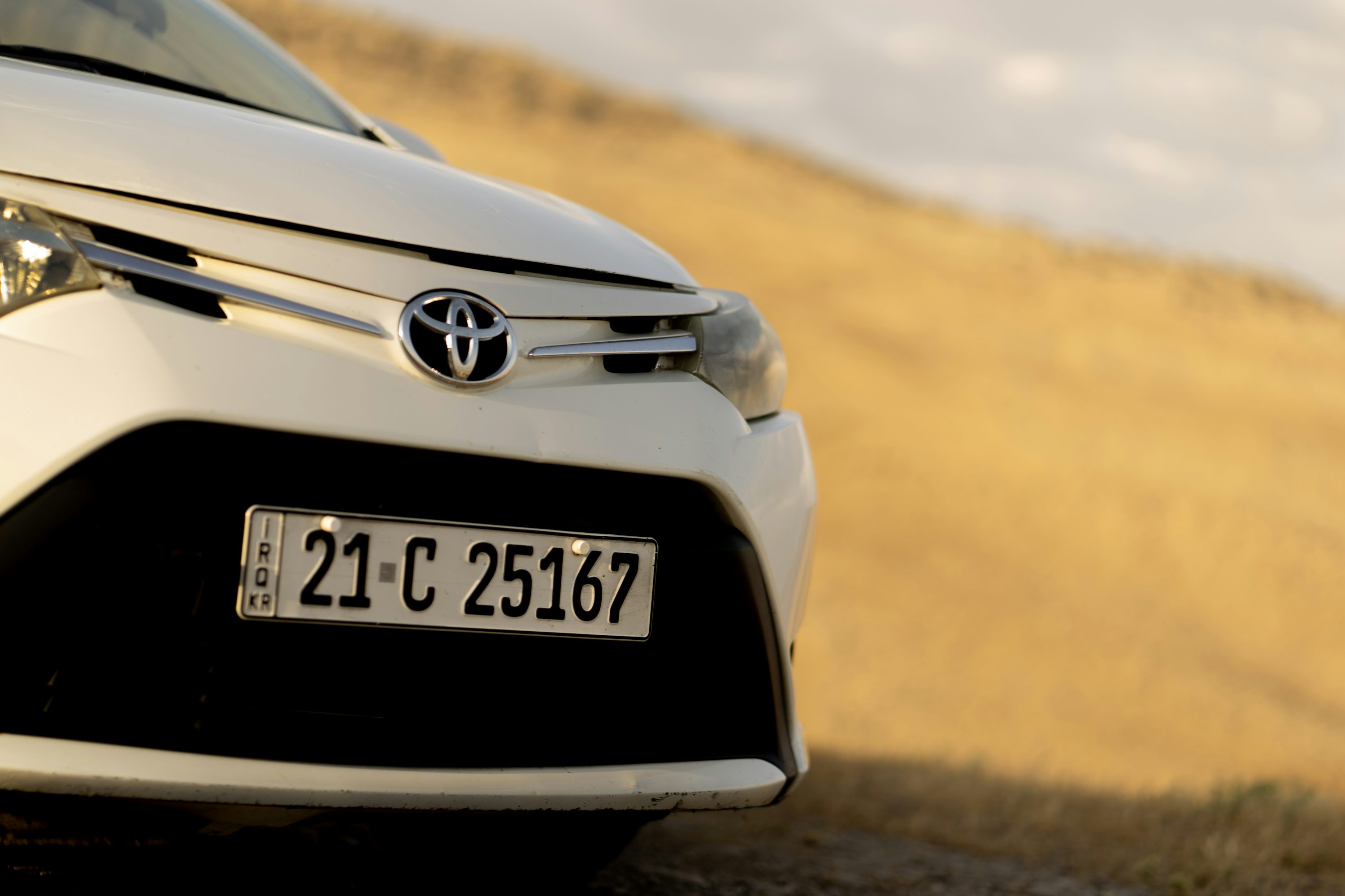A white toyota car's front close-up.