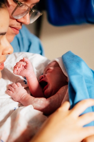 Parents gaze upon their newborn baby.