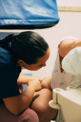 A medical professional assists a woman in labor
