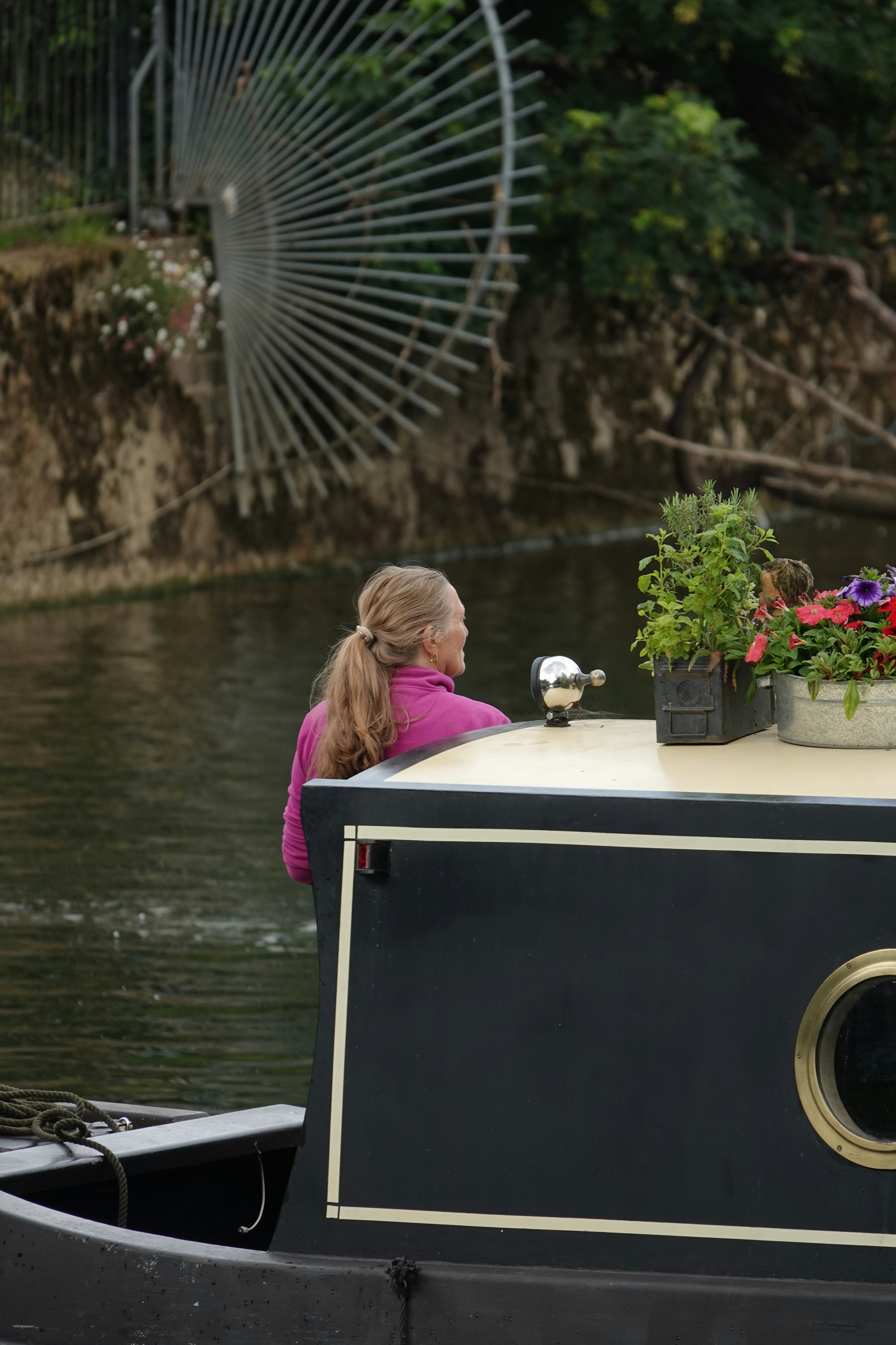 Woman on a boat looks at the water.
