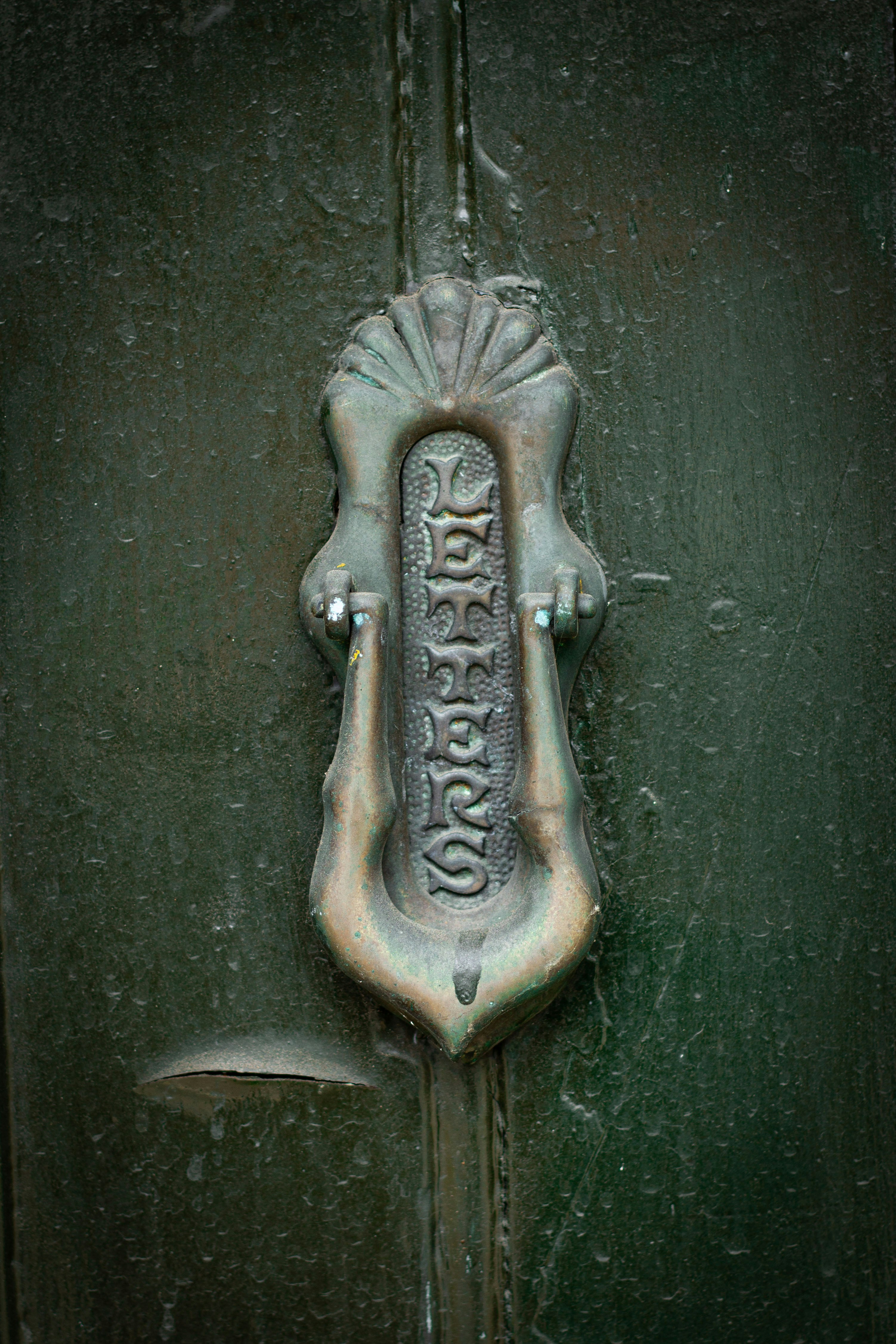 An ornate door knocker is shown.