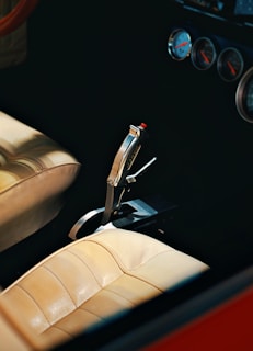 A classic car's shifter and dashboard.