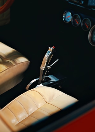 A classic car's shifter and dashboard.