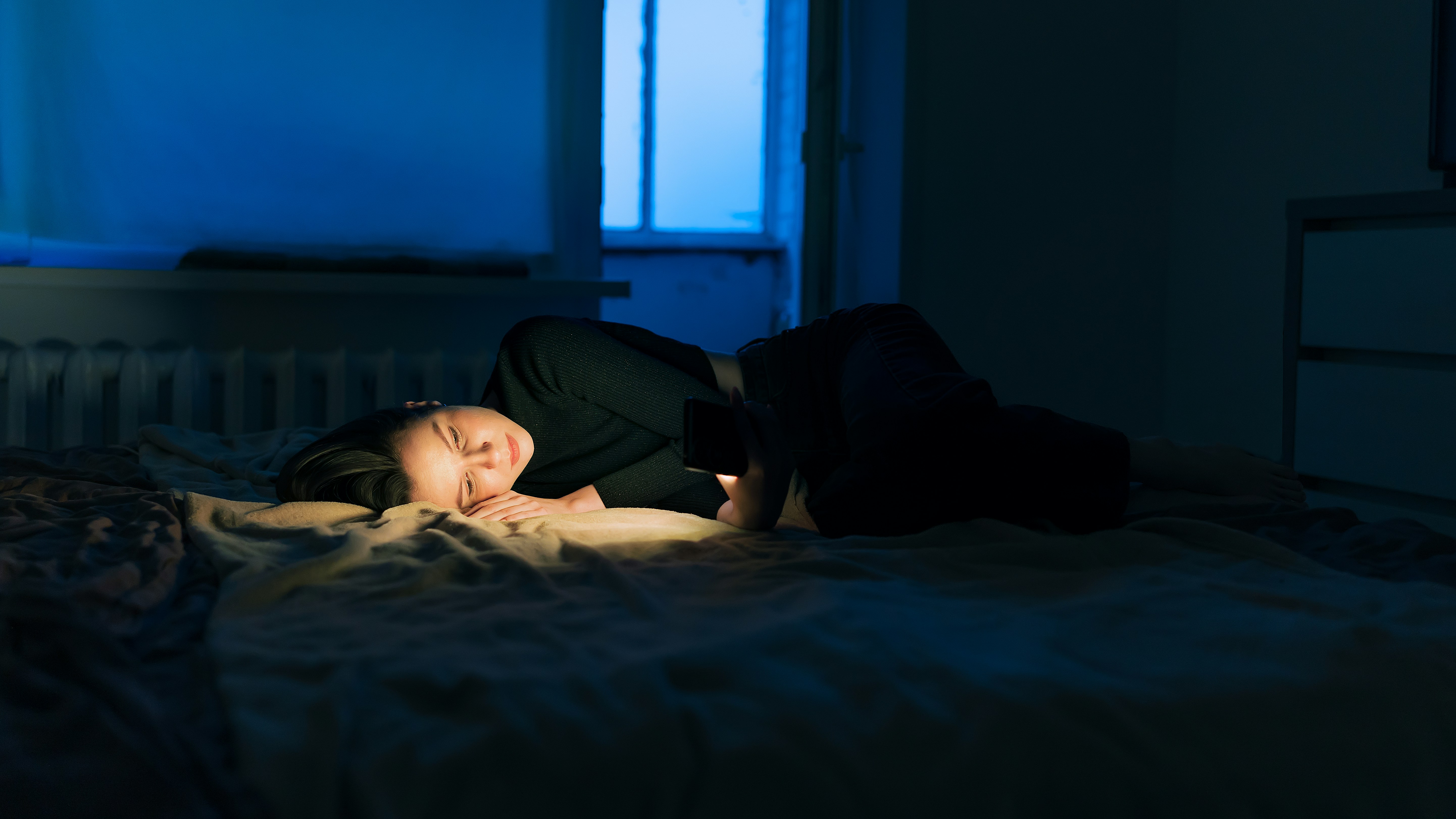 A person sleeping peacefully in a dark room, emphasizing the importance of rest for workout recovery - workout recovery