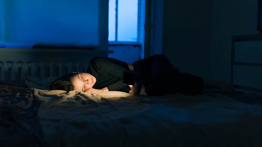 A person lying awake in bed in a dark room, unable to sleep