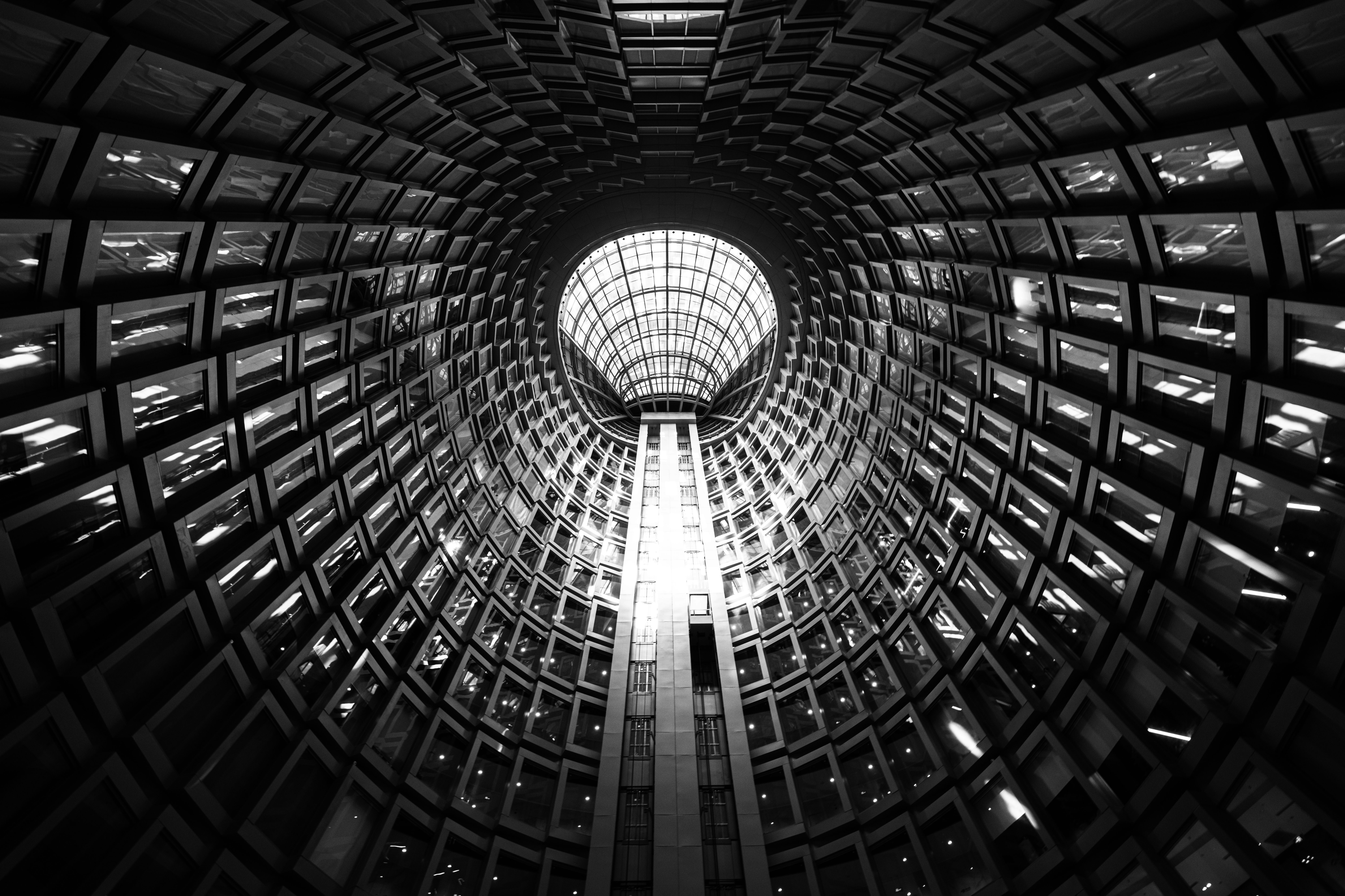 Looking up inside of a unique architectural structure.