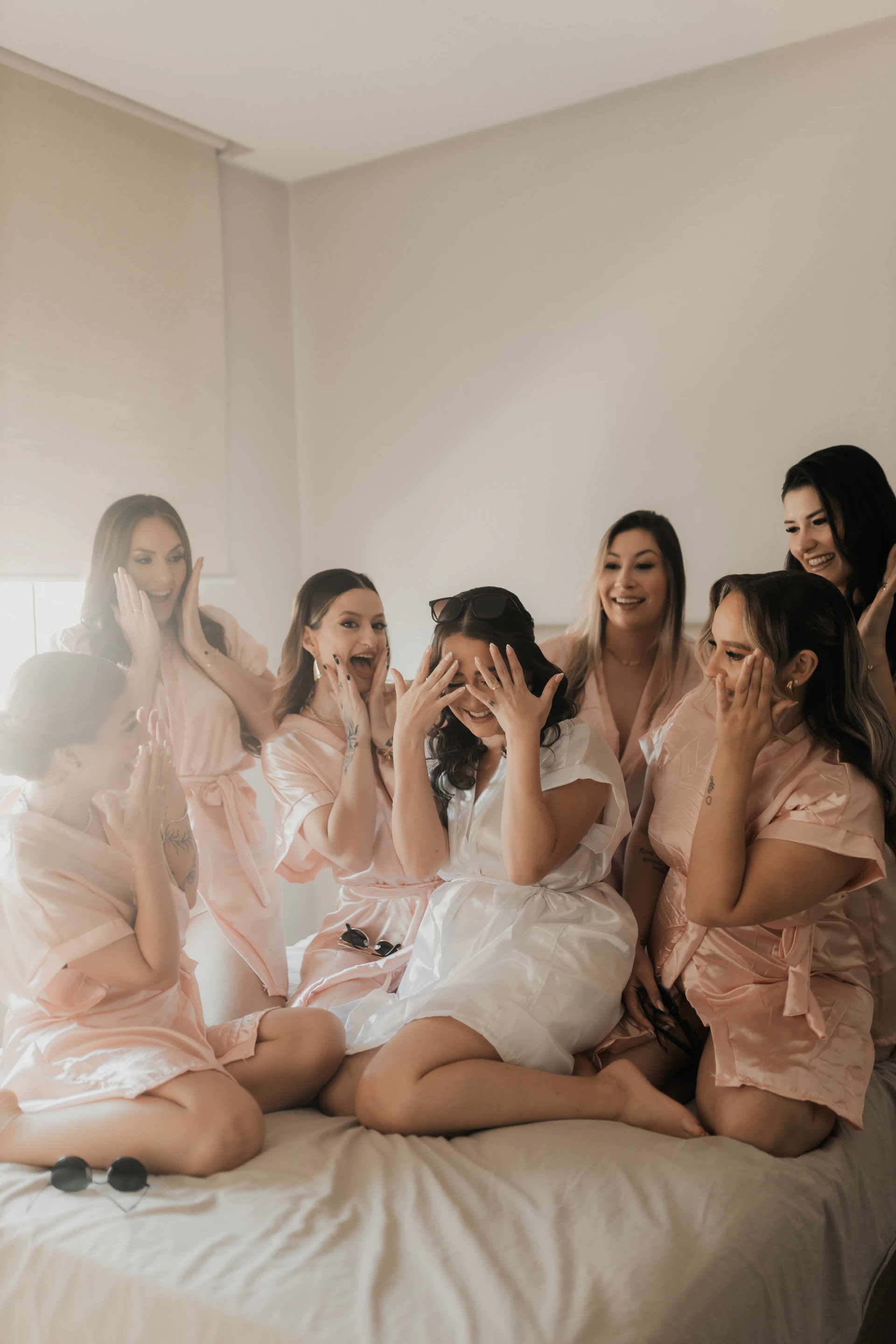 Bridesmaids and bride celebrate joyfully together.