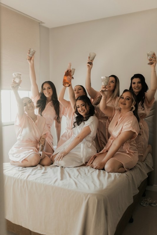 Bridesmaids celebrate with the bride before the wedding