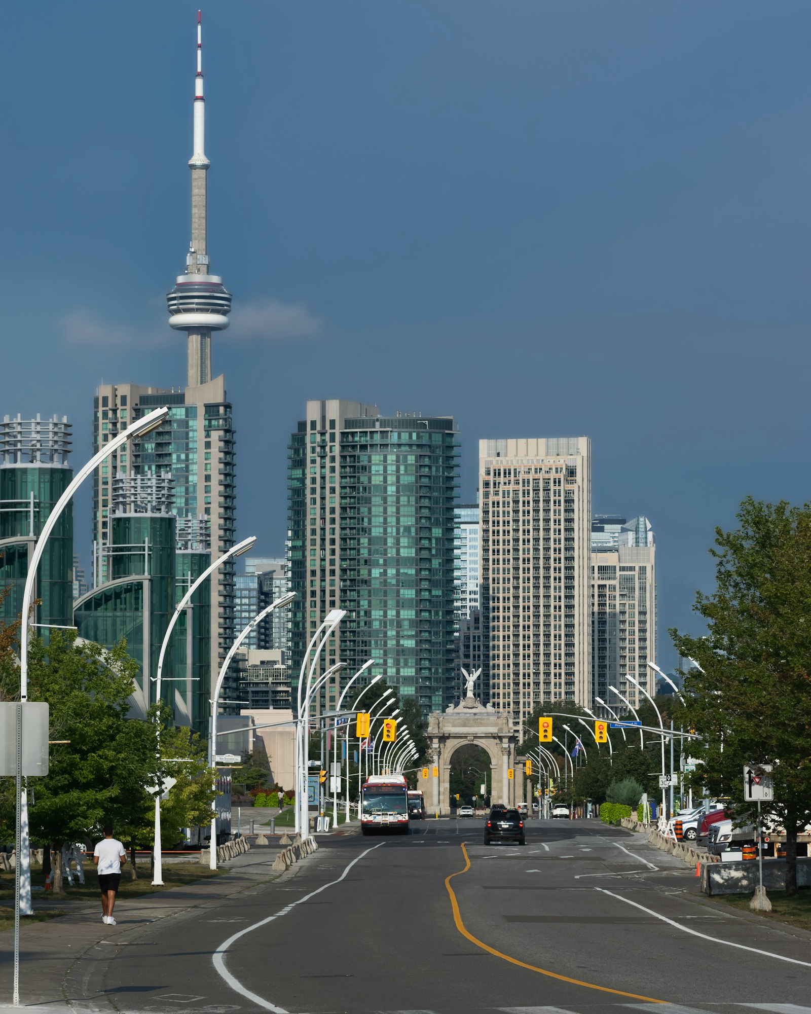 Daytime street view of downtown Toronto with the CN Tower rising above Exhibition Place