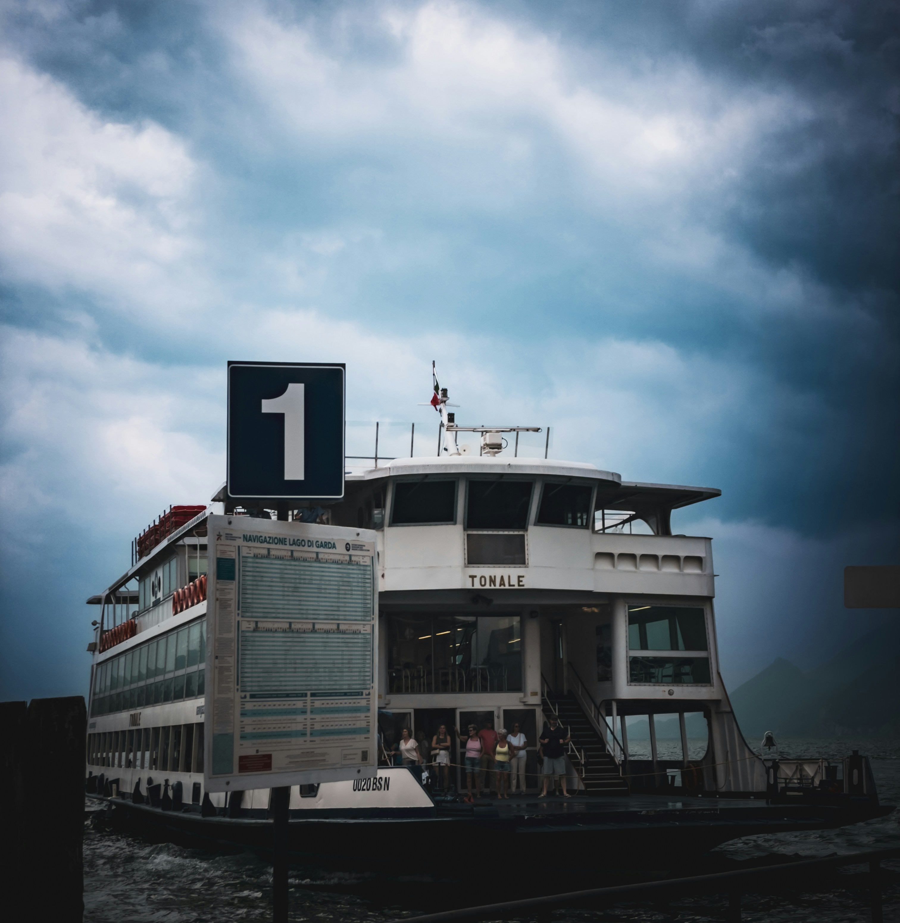 A ferry is ready to depart under a stormy sky.