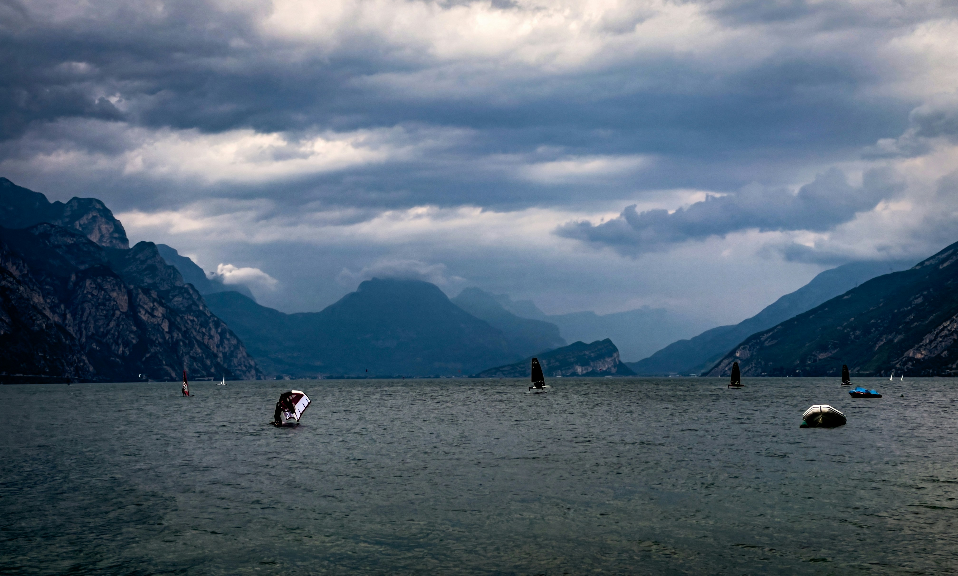 Gloomy clouds loom over mountain lake.
