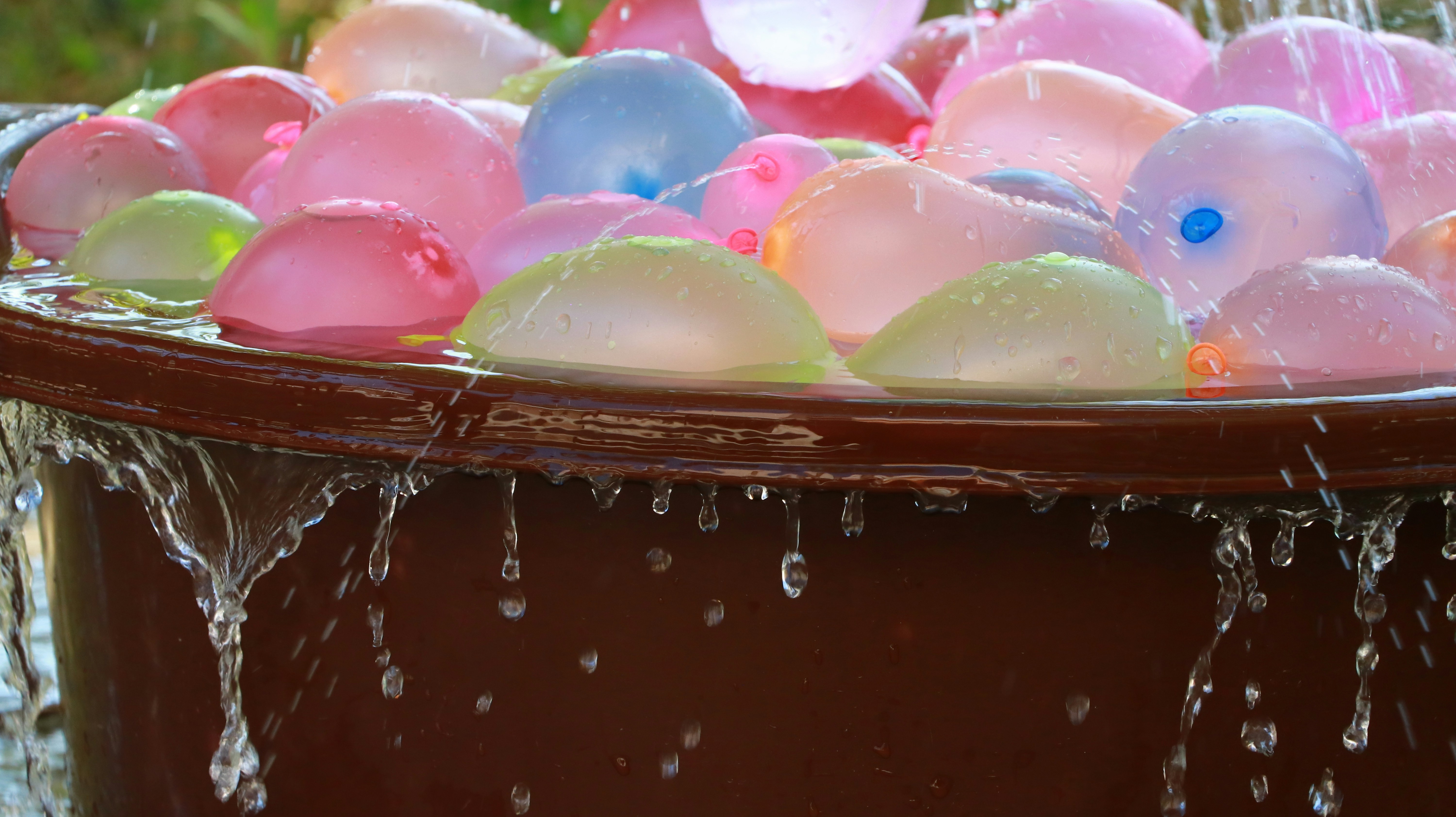 Water balloons overflowing from a brown tub.